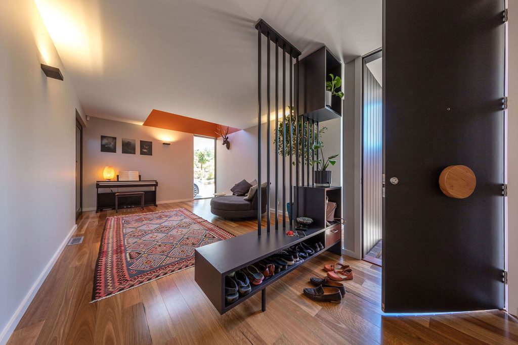 Image shows the energy efficient entryway and lounge area of a modern house.