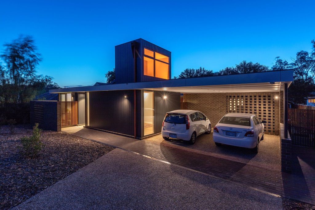 Image shows the energy efficient retrofit with the snorkle of the house visible above the roofline.