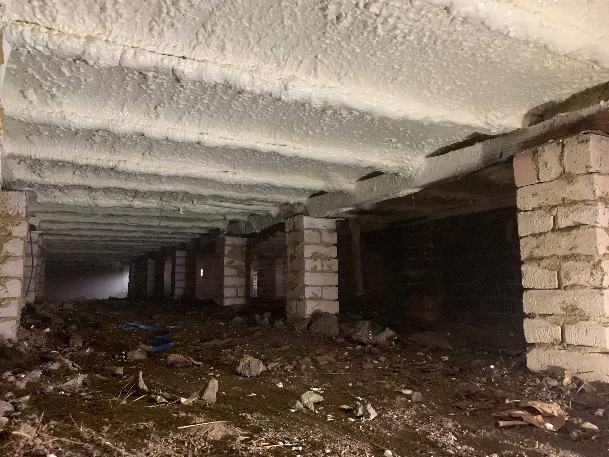 Spray foam insulation installed under a timber floor.