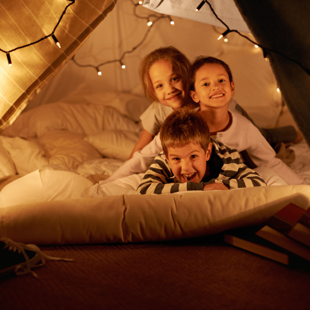 Happy kids in comfortable home cubby.