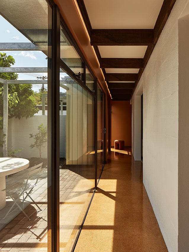 Image of a high performance home corridor with large windows and sunlight streaming in.