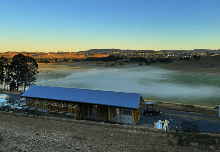 Image shows a strawbale home looking over a valley in Deloraine Tasmania.