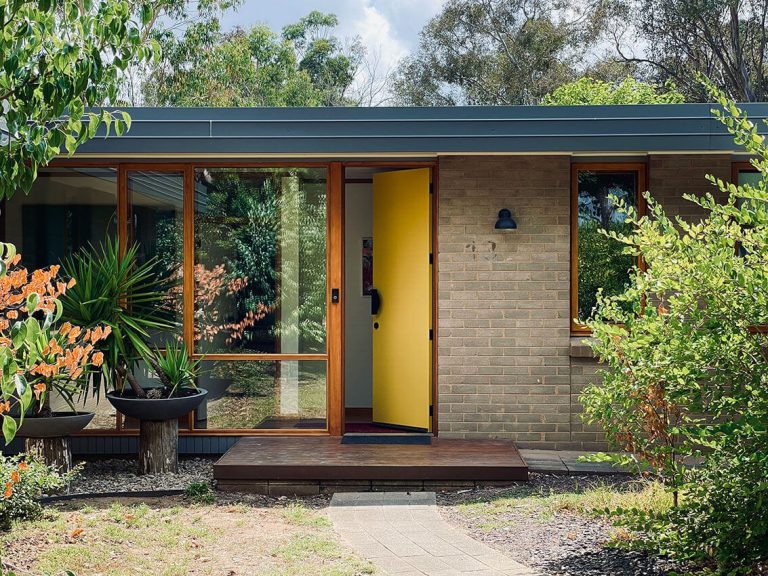 Image of the yellow front door and windows of the 6 star home architecturally updated by the Mill Architecture and Design