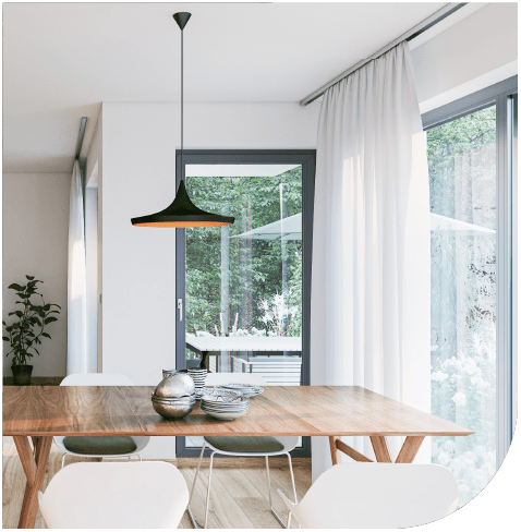 Image of an energy efficient house with windows to the garden and a timber dining table